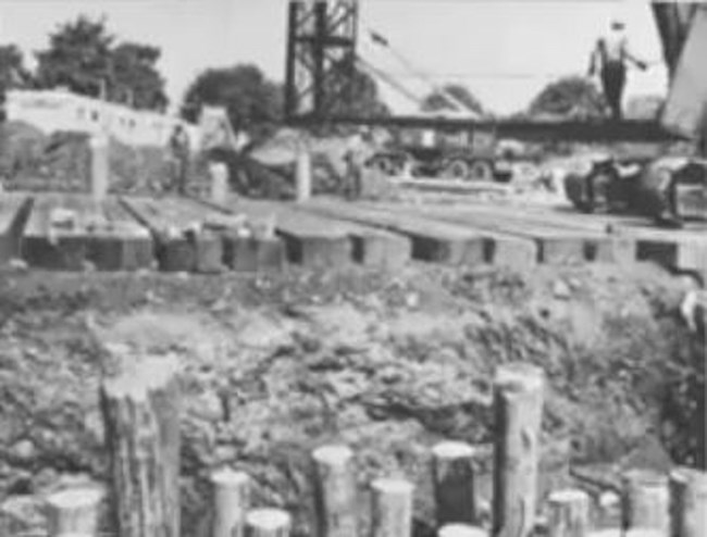 Foundation of the Tent of Tomorrow- wood piles.