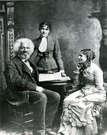 Frederick Douglass, Helen and Eva Pitts. From left to right, photograph of Frederick Douglass, Eva Pitts, Helen Pitts sitting for a portrait. Both Frederick and Eva looking into the camera while Helen looks at Frederick.