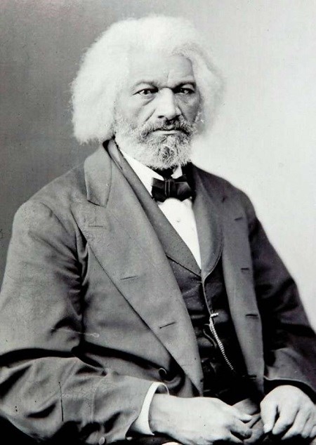 An aging, white-haired, African American man, Frederick Douglass sitting