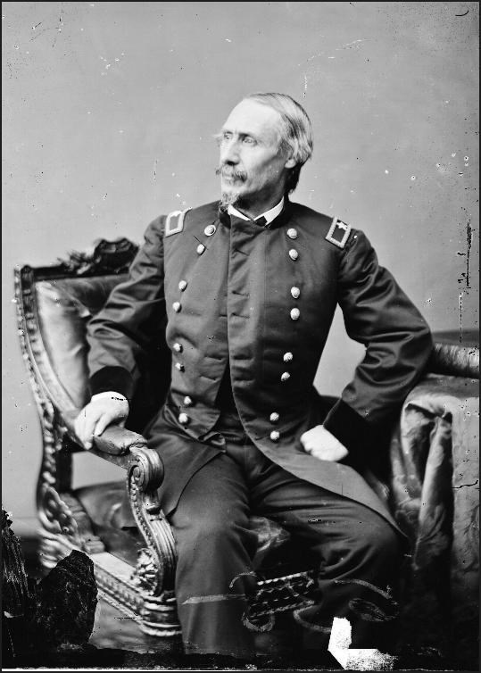 Black and white portrait of military general in uniform sitting in a chair facing left