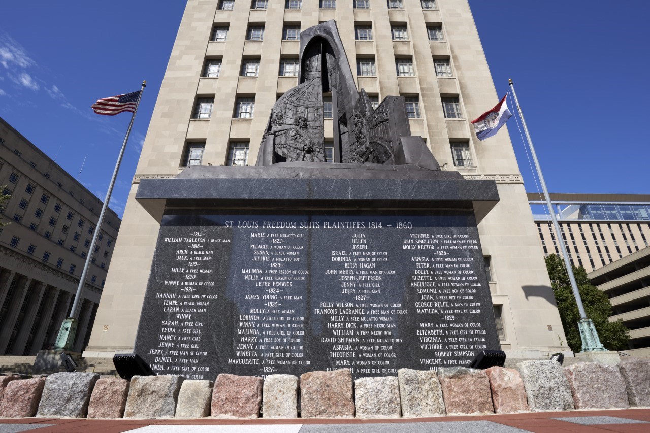 Freedom Suits High-Res WashU Large Memorial statue made of granite in front of courthouse building.