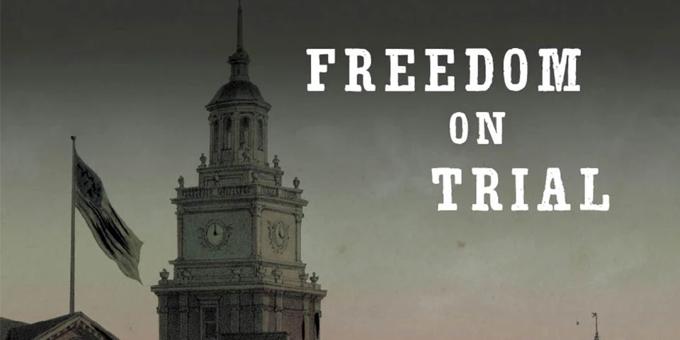 Illustration depicting the tower of Independence Hall with the words "Freedom on Trial" in bold white text. Illustration depicting the tower of Independence Hall with the words "Freedom on Trial" in bold white text.