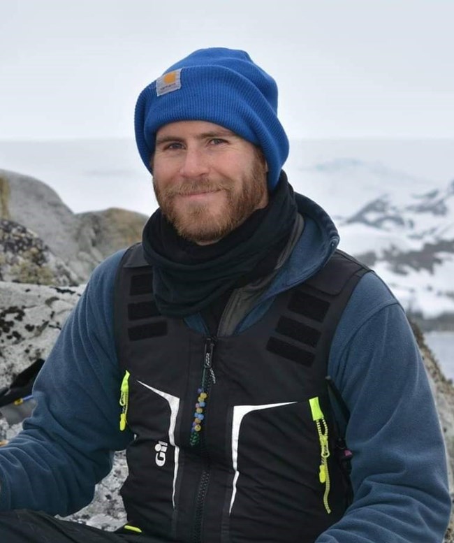 A man in a cold-weather jacket and hat.