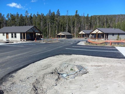 Prototype Housing at Grand Teton National Park Prototype housing at Grand Teton National Park with paved road and parking area in foreground.