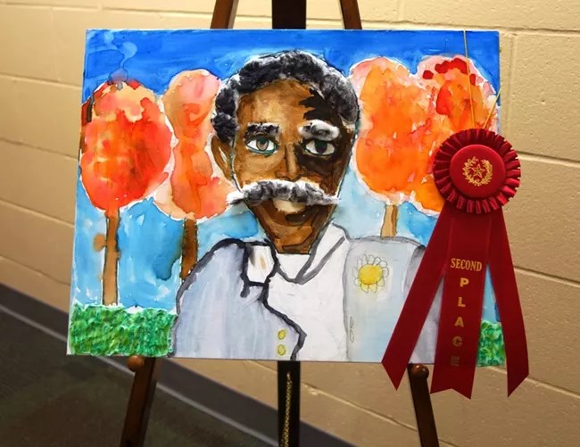 GWCA Art and Essay Contest NPS Child's painting of George Washington Carver with an award ribbon hanging from it