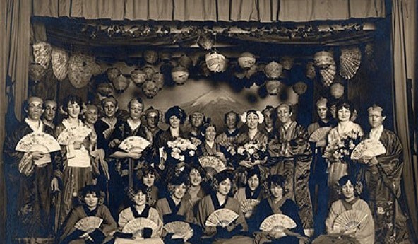 Cast of Gilbert and Sullivan's operetta "The Mikado" Black and white photo of men and women on stage for a performance.