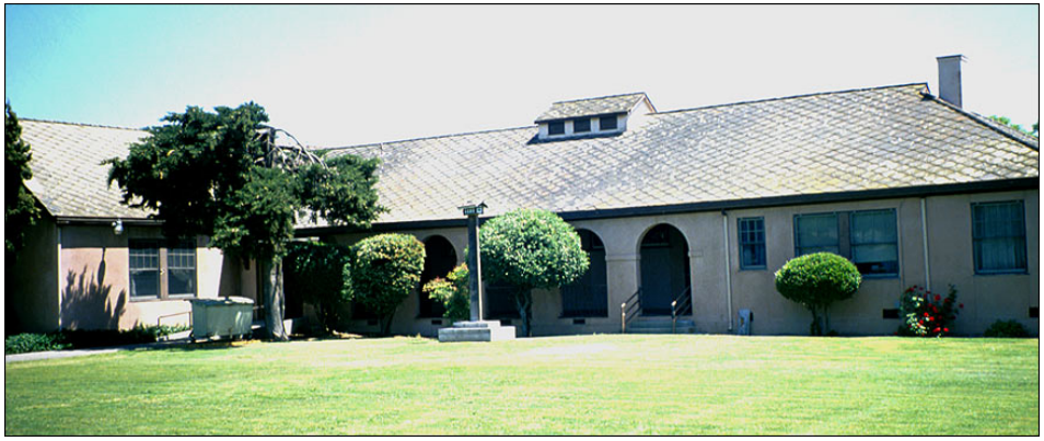 A one-story building on a lawn