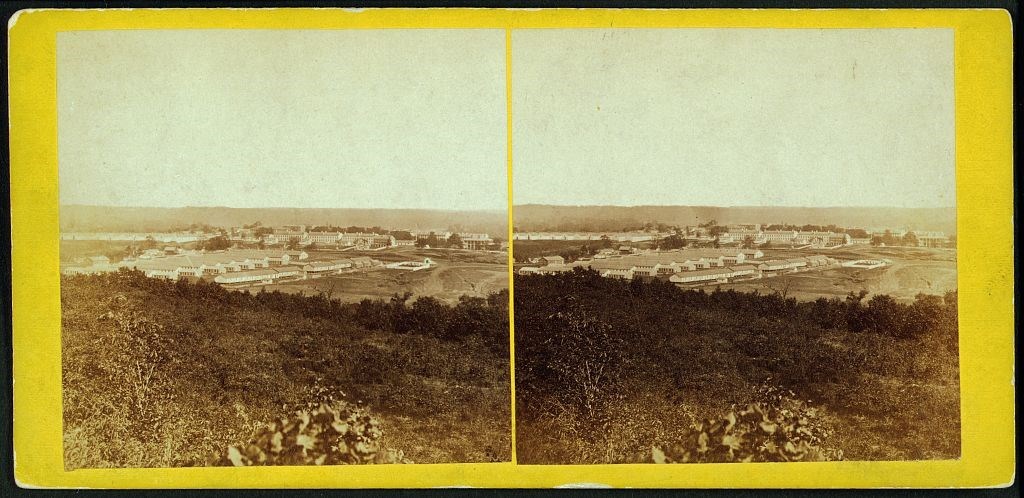 Sepia tone photograph overlooking fort buildings