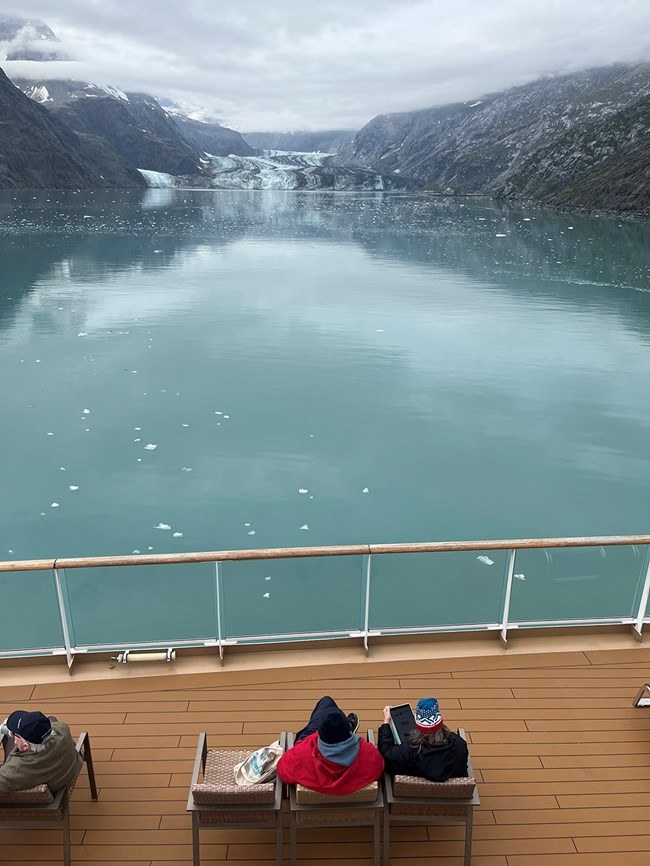 Gende_Fig3_web People on a cruise ship deck enjoy a longer view of a glacial inlet.