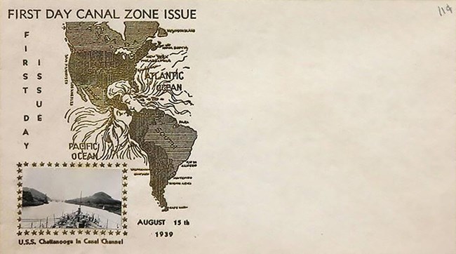 An unused envelope with a cachet (design) on the left side showing a map of the Americas. At the location of the Panama Canal, the waters of the Atlantic and Pacific Oceans (represented by women with flowing hair) meet.