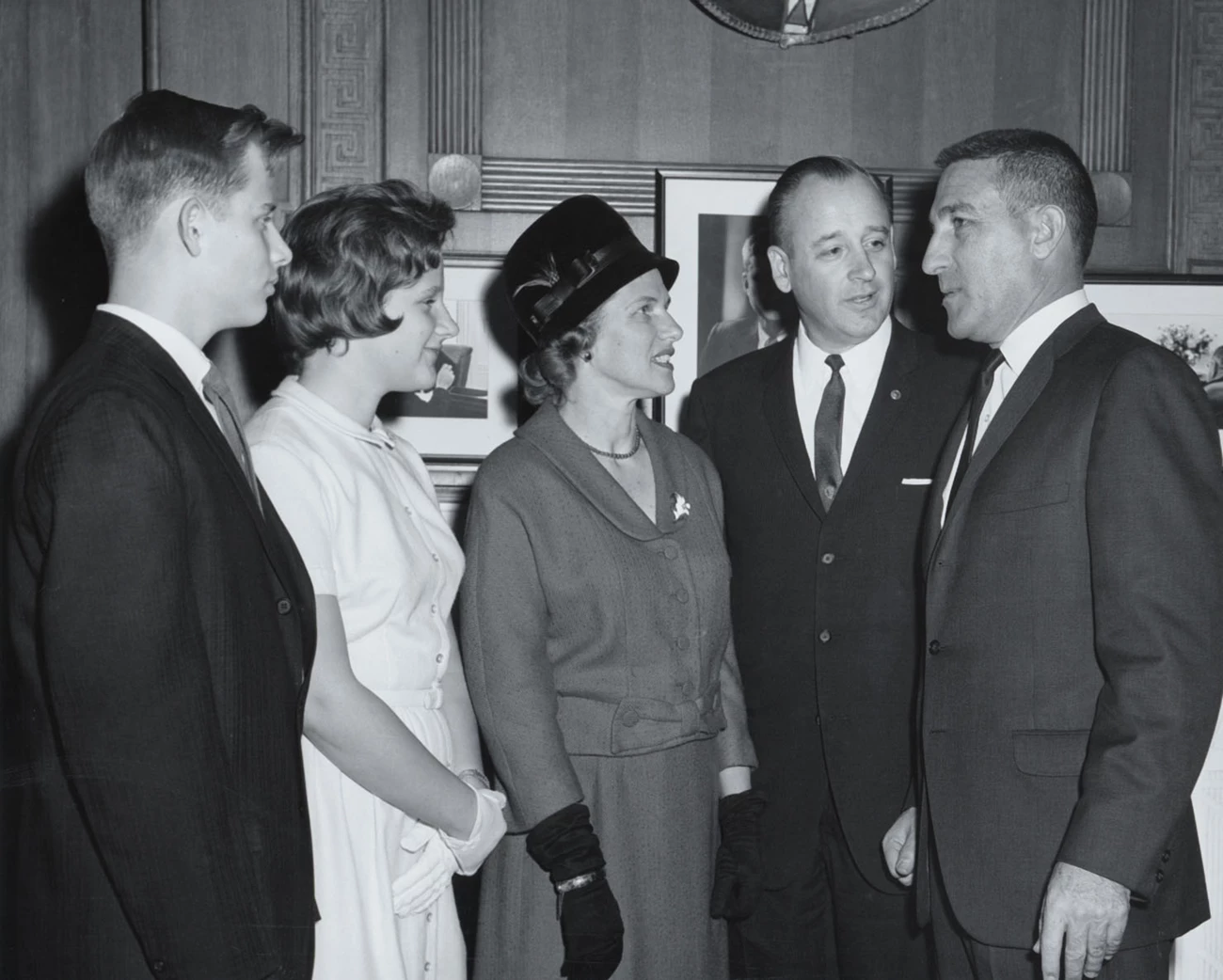 The Hartzogs and Steward Udall Four Hartzogs stand next to Steward Udall inside an office