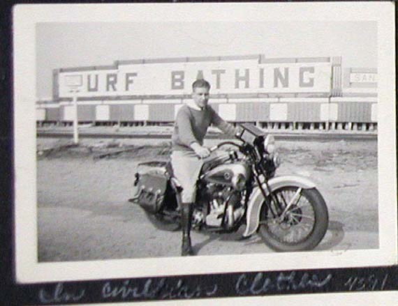a young man poses on a motorcycle