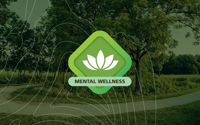 A green diamond graphic with a lotus flower in the center and the words Mental Wellness on top of a green tinted photo of the Carver trail.