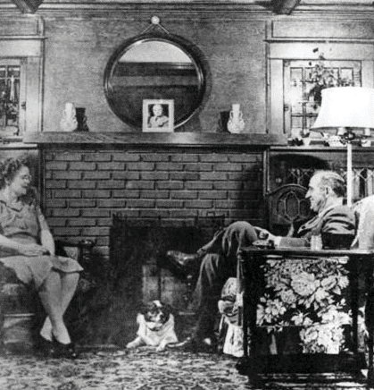 George and May Wallace Picture of George and May Wallace sitting inside their home by a fireplace