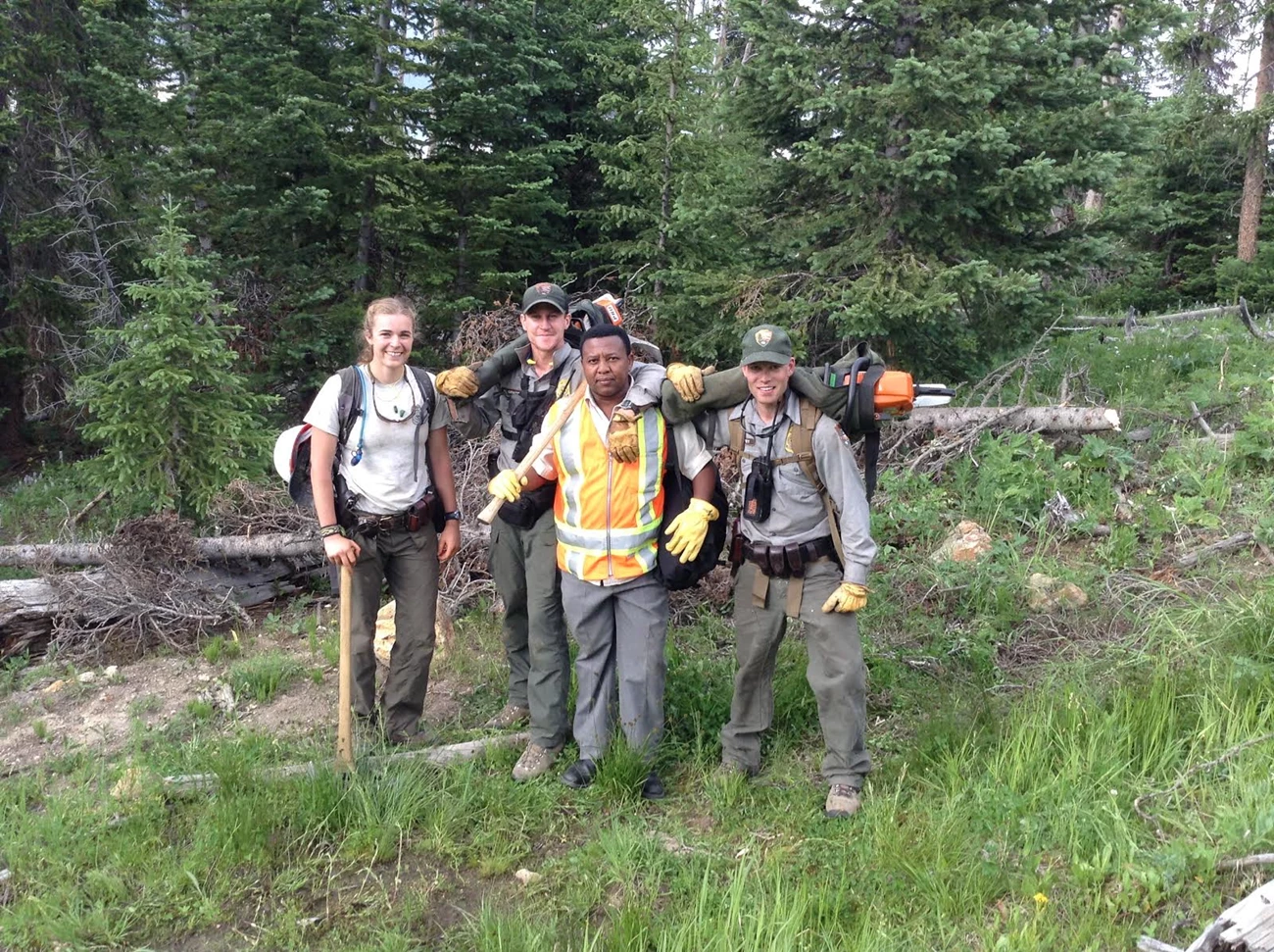 Godson at Yellowstone NP 2013 four young people posing for picture with trees in the back