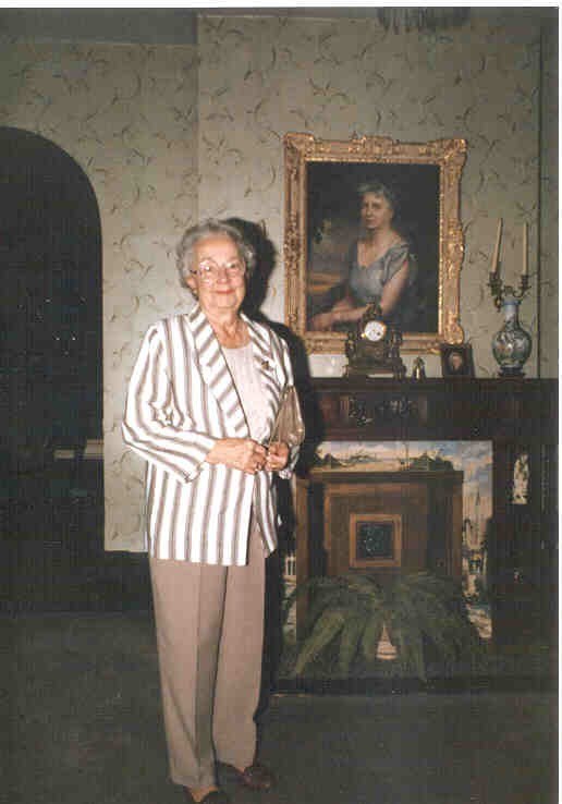 Hazel Graham, with painting of Bess Truman behind her.