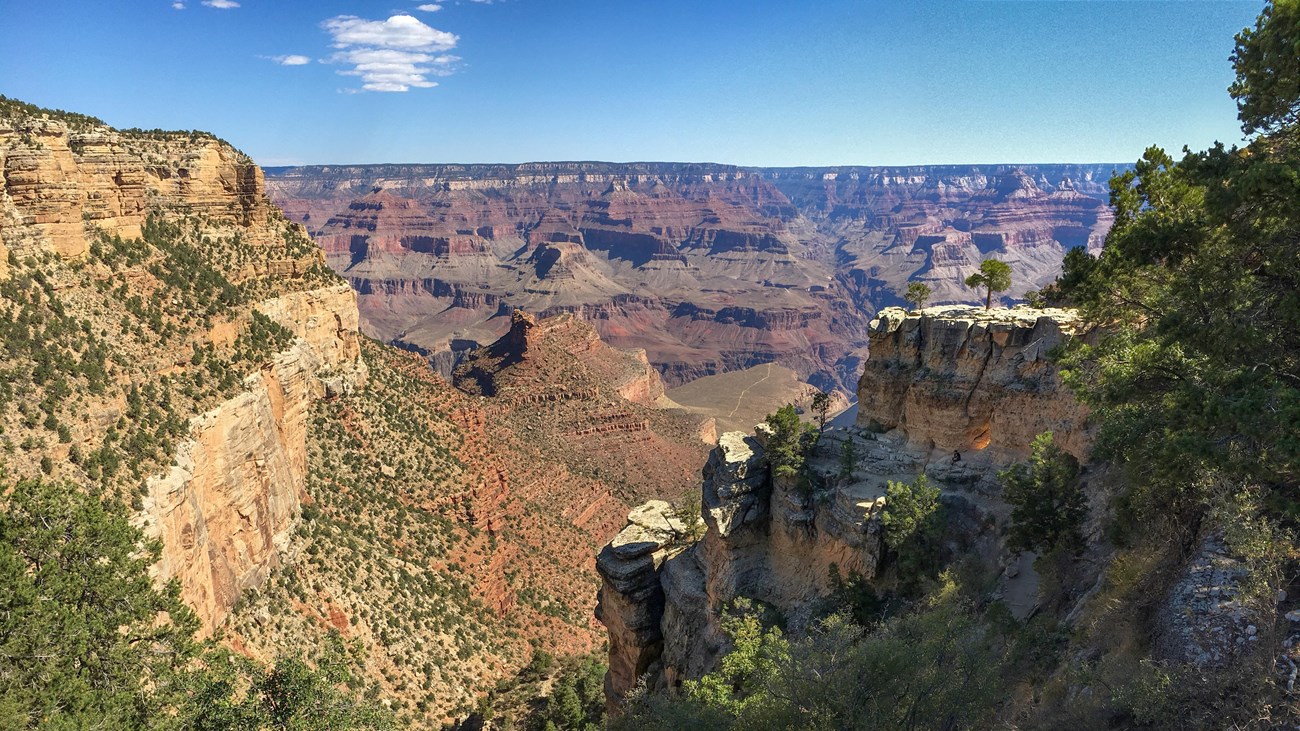 Red stone stretches in layers in an expansive landscape