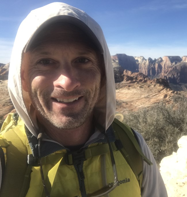 Greg Bartin with mountains in background