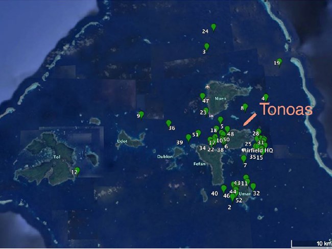 Google earth image of Chuuk Lagoon, 6 island atoll in Pacific Ocean surrounded by green markers for 52 shipwrecks
