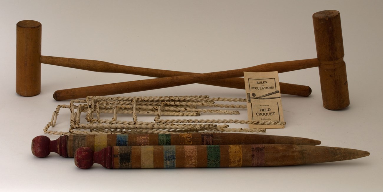 croquet set a color photograph of an antique croquet set with instruction manual.