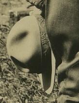 Close up of Albright's hatband on his hat. Close up of a ranger hat in a man's hand. Letters NPS are on it.