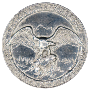 First NPS eagle badge design round silver badge with an eagle in the center