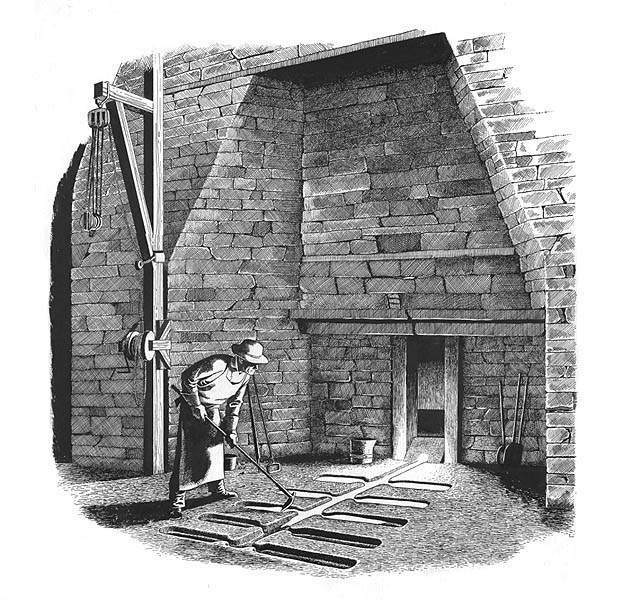 A person standing in front of a brick structure holding a rake-like object over several troughs.