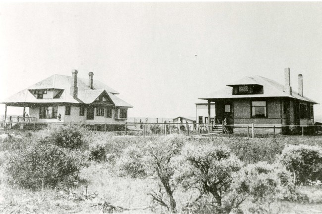 Homes in Hanford c. 1912 Black and white photo of two homes in sagebrush. The homes are side by side.