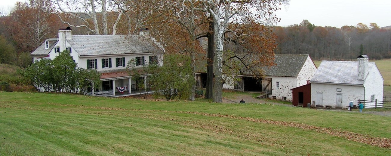 White house and barn in a field. White house and barn in a field.