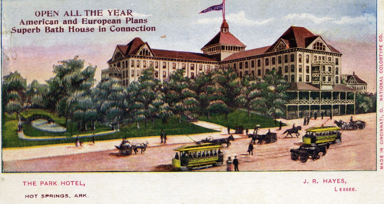 The Park Hotel. Illustration of a large building with white bricks and a red roof. A flag flies above the building. In front of the building are trees and a road full of yellow streetcars and horses.