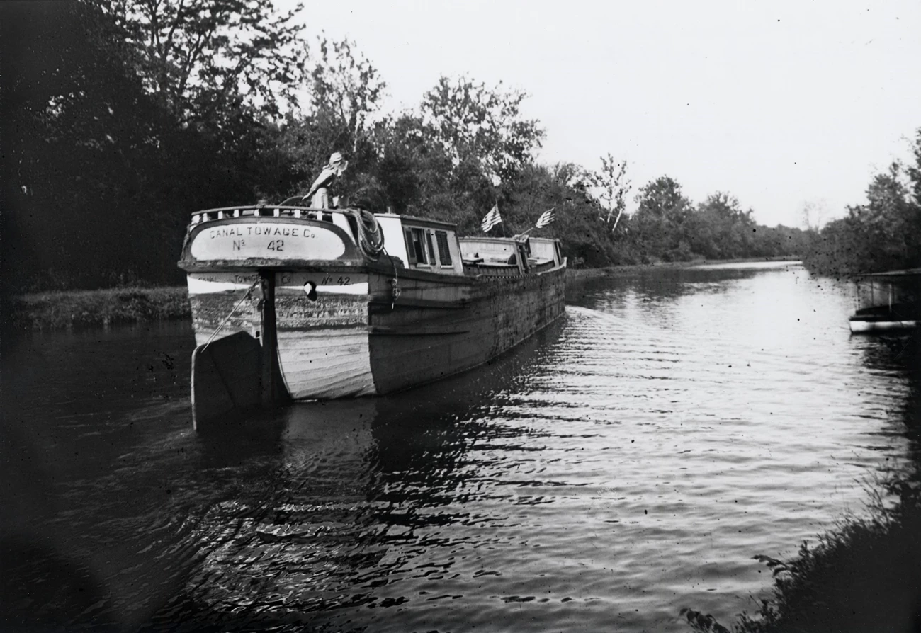 Woman at the tiller of a canal boat Woman at the tiller of a large canal boat