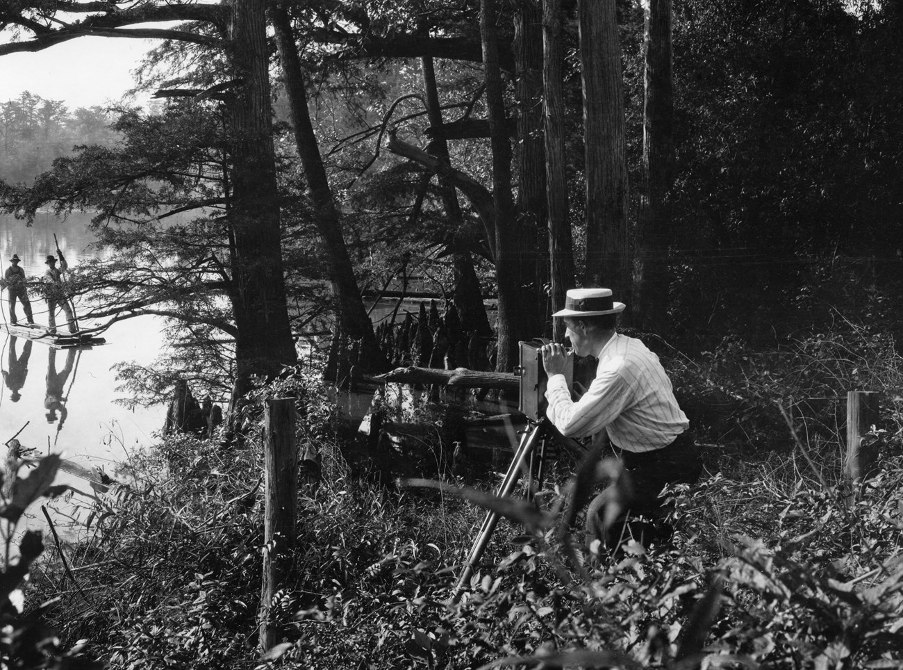 E.B. Thompson films two men on a skiff in the Everglades