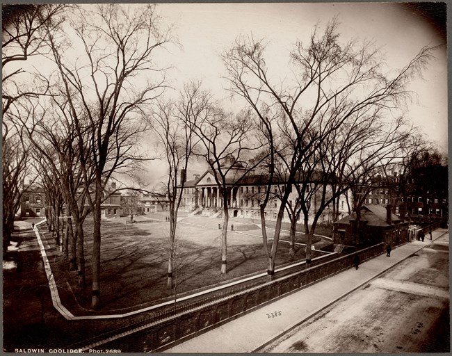 Massachusetts General Hospital with a large lawn in front with trees bordering the lawn.