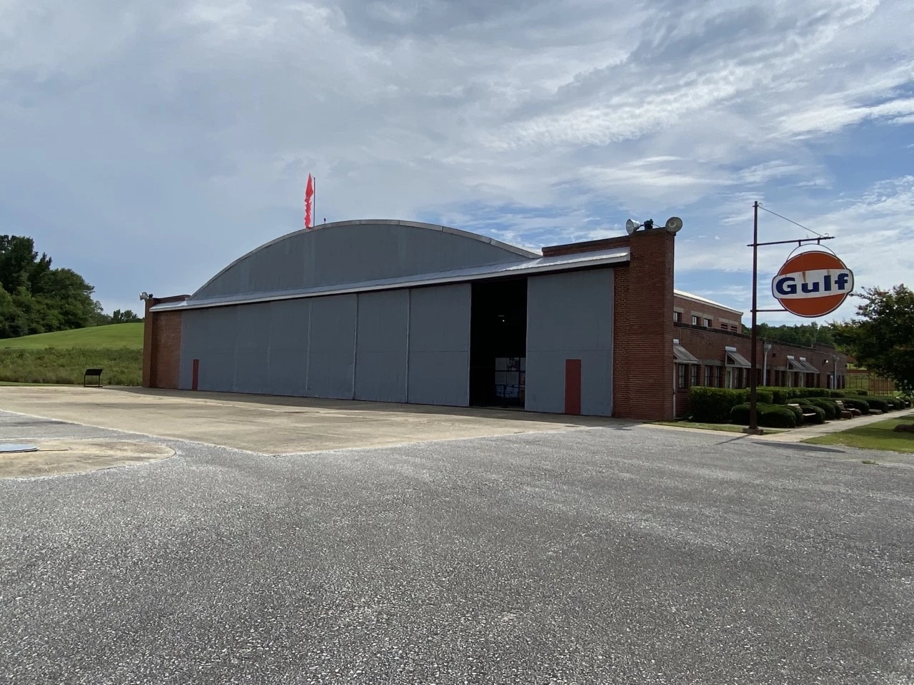 Hangar No.1 museum at the National Historic Site. Moton Airfield (including two Hangars) is part of Tuskegee Airmen National Historic Site. It is located near Tuskegee University (formerly, Institute, and also a National Historic Site). Shown here is an angled view of  Hangar No. 1 museum.