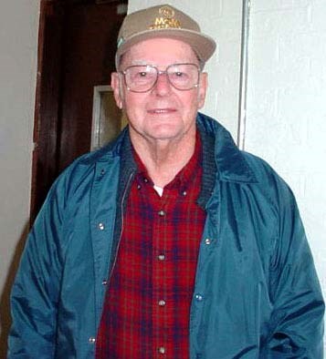 an old man with a ball cap and glasses