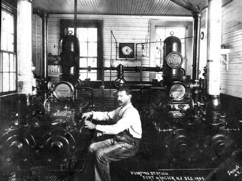 a man works inside a vintage pumping station