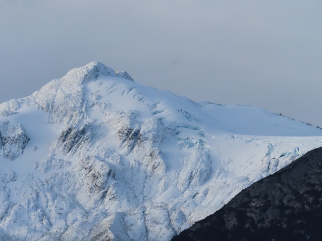 A glacier that resembles a snow and ice covered mountain.