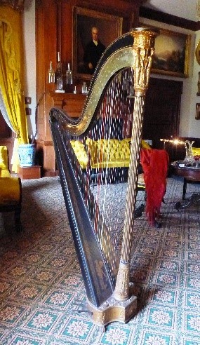 Modern day photo of Eliza's harp on display in the music room