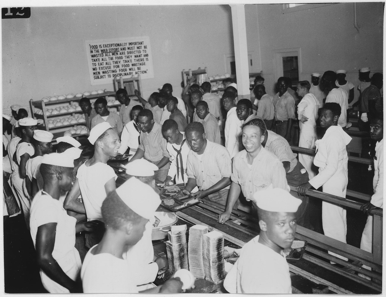 men in navy work uniforms in line at cafeteria