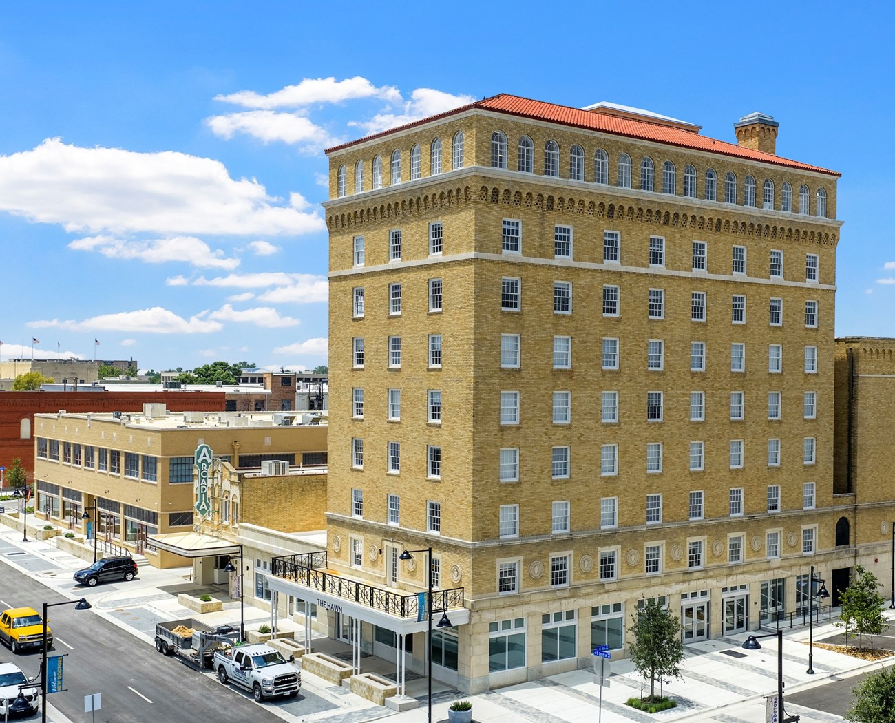 A large multistory building with architectural detailing. On the same block sits the Arcadia Theater.