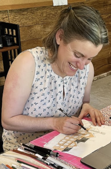 Heather Heckel A woman smiles while working on a piece of art