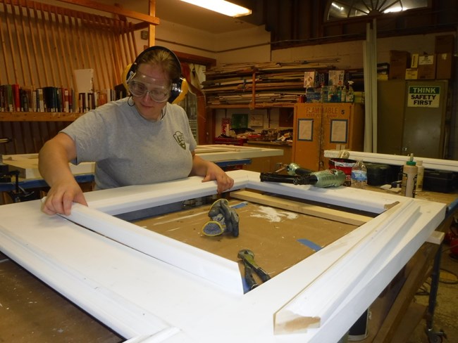 Helen preserving a window frame, one of the many pieces of a historic site.