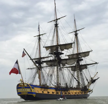 three masted tall ship with french flag flying from the stern.