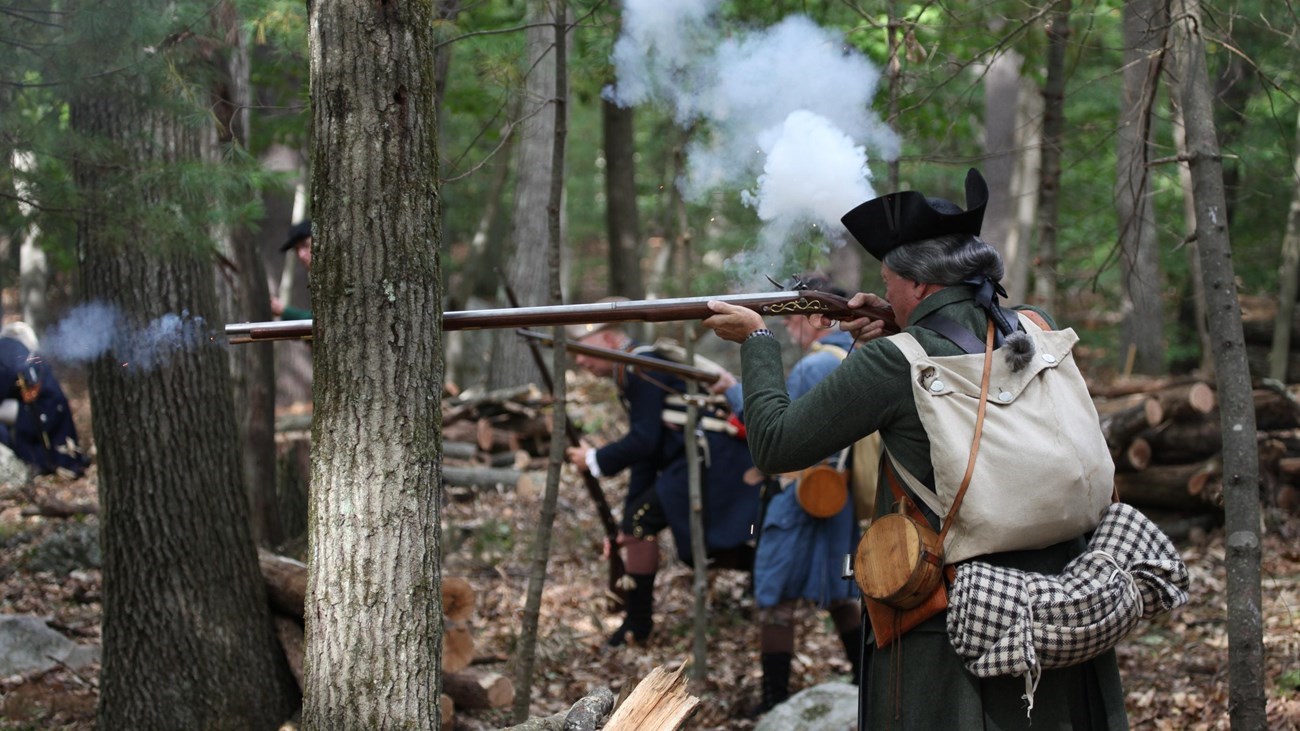 Highlight 09 - East Pikeland Township_French Creek Park Service Volunteers are shown demonstrating Revolutionary War combat techniques in a wooded area.