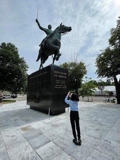woman taking picture of equestrian statue