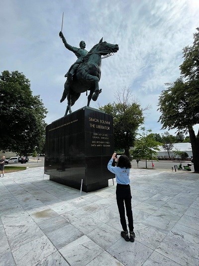 Hillary Morales Statue Simon Bolivar woman taking picture of equestrian statue