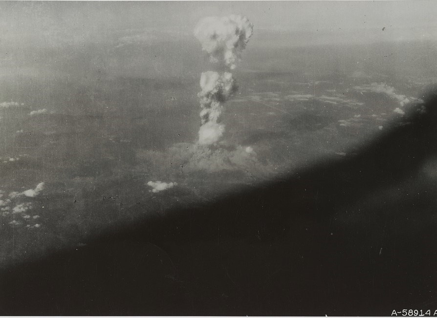 Aerial photo of Hiroshima mushroom cloud in distance, tall and narrow explosion