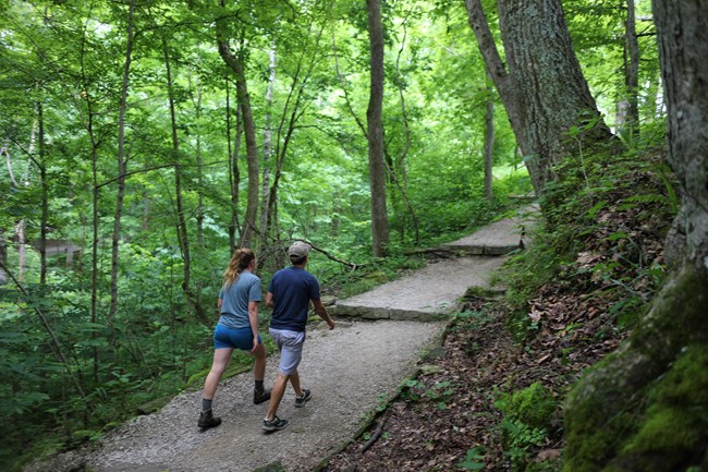 Two people hiking on a trail.