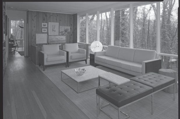 Hollin Hills 2B2LB Black and white HABS photograph showing a large open living room with sofa and chairs on a rug and a wall of glass windows.