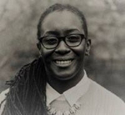 Headshot of an African American woman with glasses smiling